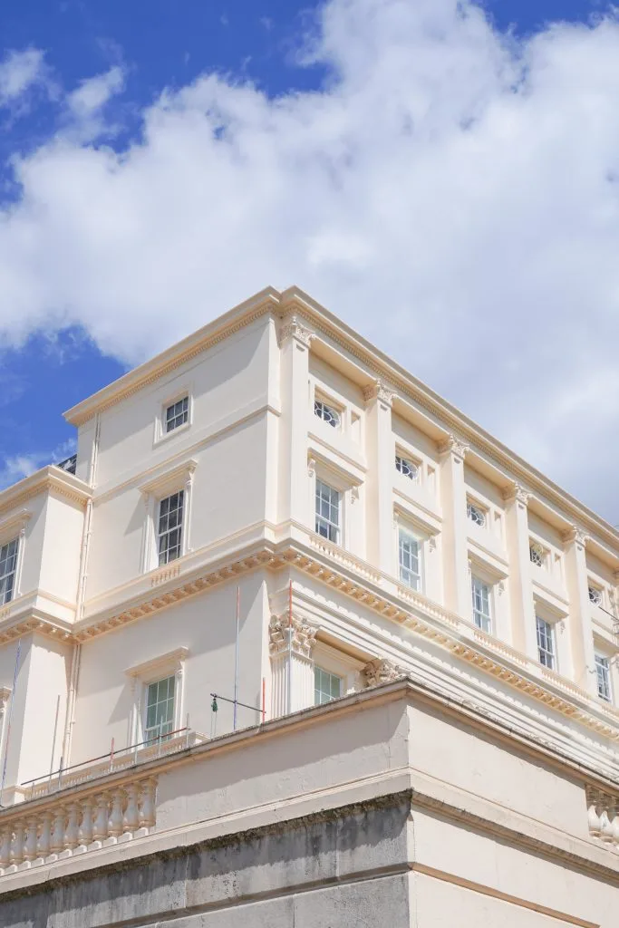 Exterior view of a grand, cream-coloured heritage building.