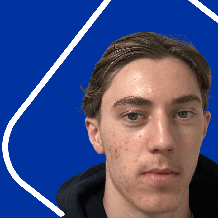 Blue background with a white line. Headshot of a man with a black top.