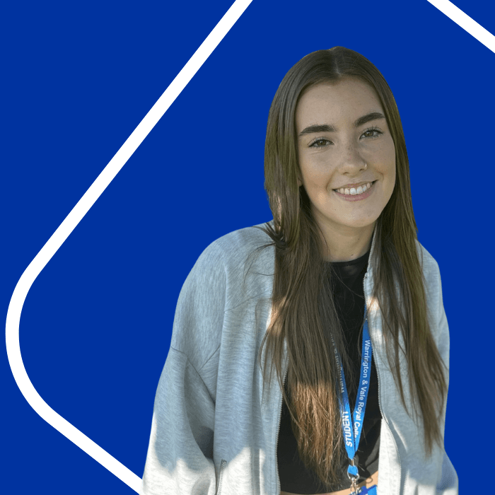 Girl with long brown hair and a grey hoodie. Blue background with a white line border