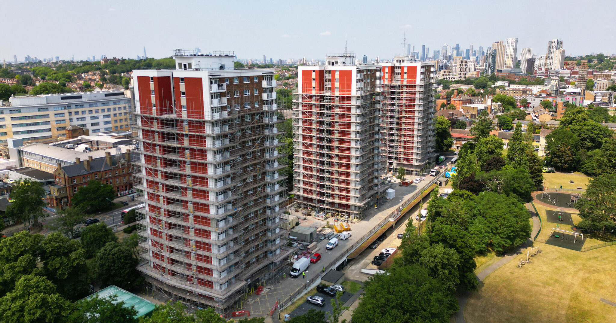 Overhead shot of three high rise buildings covered in scaffolding