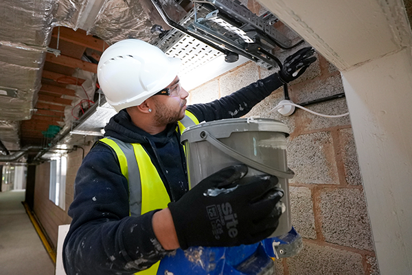 operative completing passive fire works in high vis jacket with a white safety hat