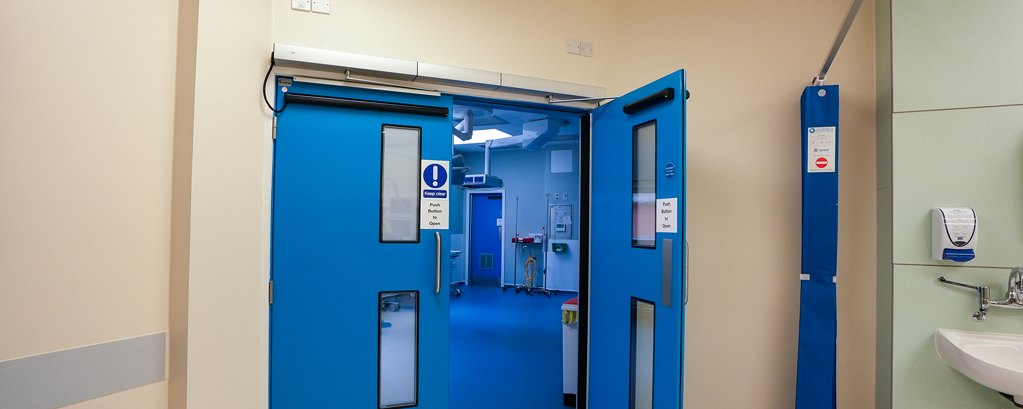 blue fire door inside a hospital ward