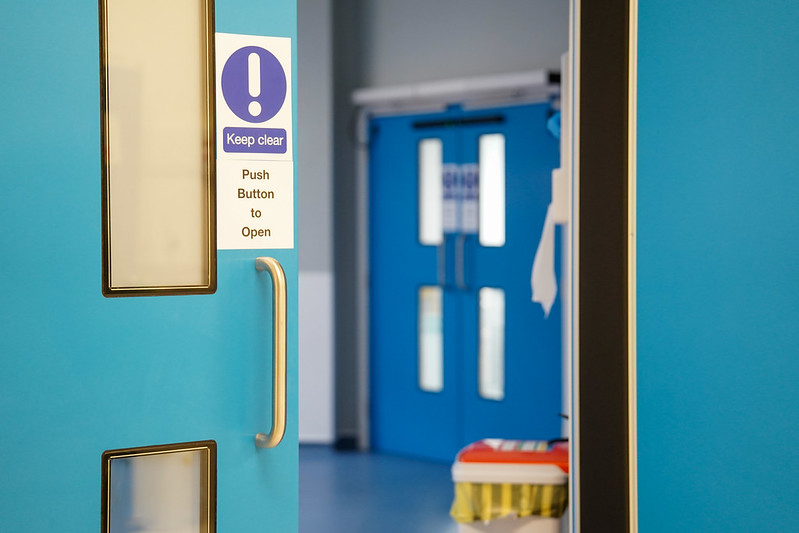 close up of a blue open fire door in a hospital