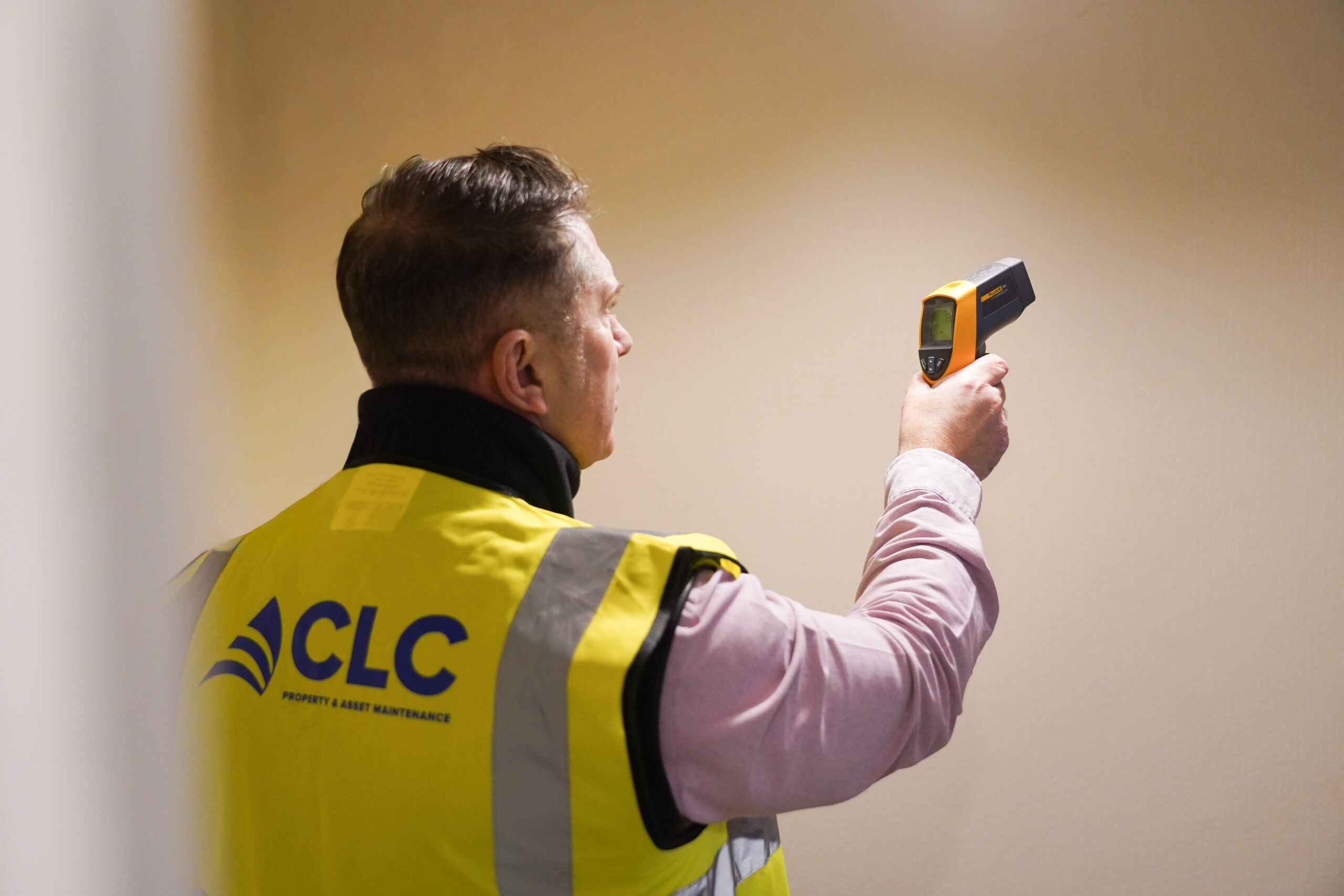 CLC employee scanning a wall for damp and mould